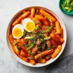 Yopokki recipe finished dish with spicy rice cakes, eggs, and green onions