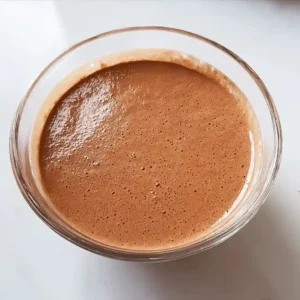 Blended cottage cheese and cocoa mixture in a glass bowl for cottage cheese fudge