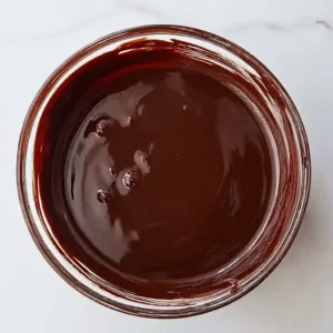 Melted dark chocolate in a glass bowl for cottage cheese fudge